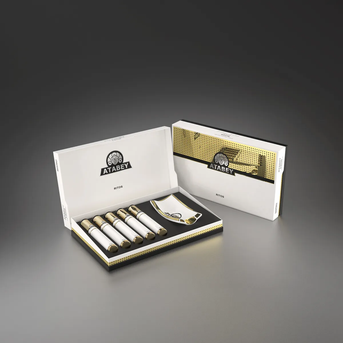 A luxurious Atabey cigar set featuring a sleek box opened to reveal five cigars and a cutter. The box has a gold and black design with the Atabey logo prominently displayed.
