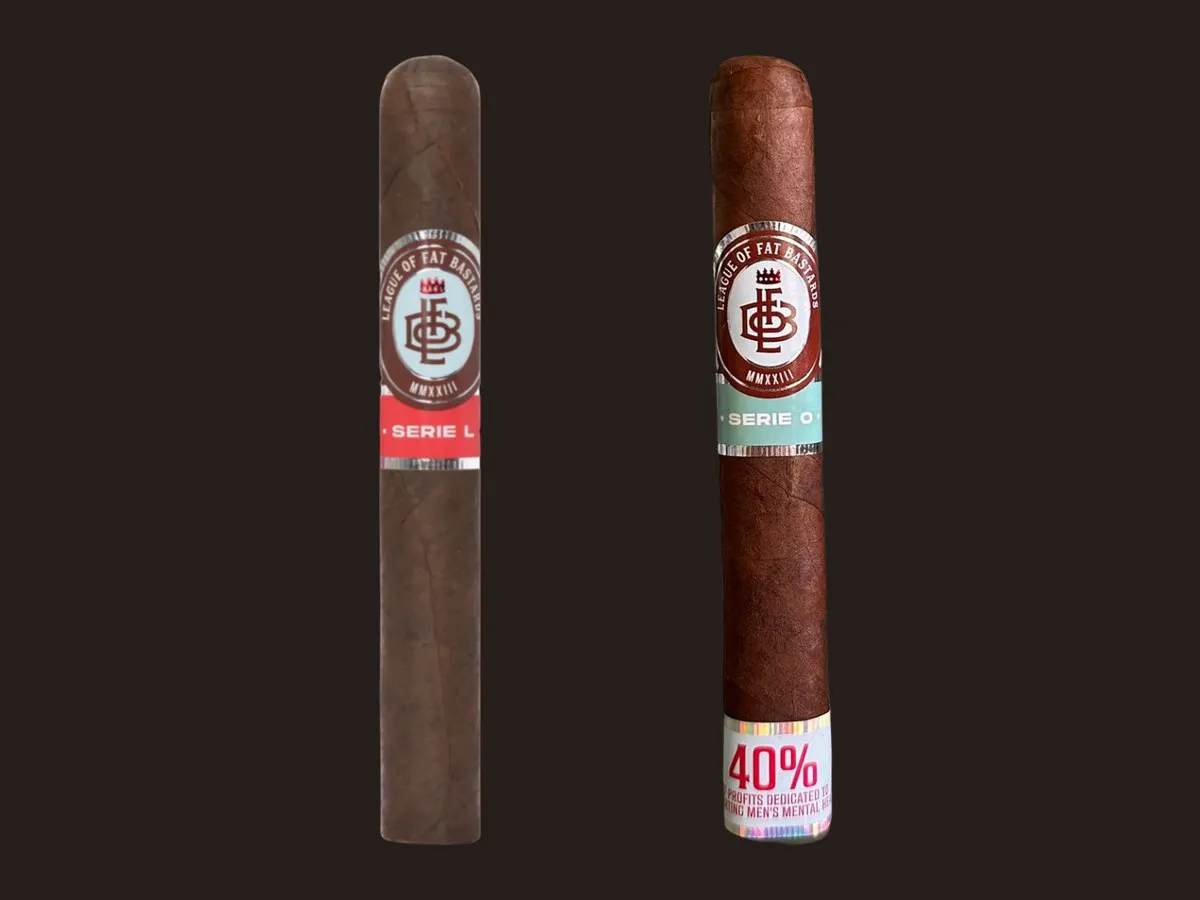 Two League of Fat Bastards cigars side by side: a dark Serie L with a red band and a Serie O with a teal band and a 40% foot band about profits for men's mental health