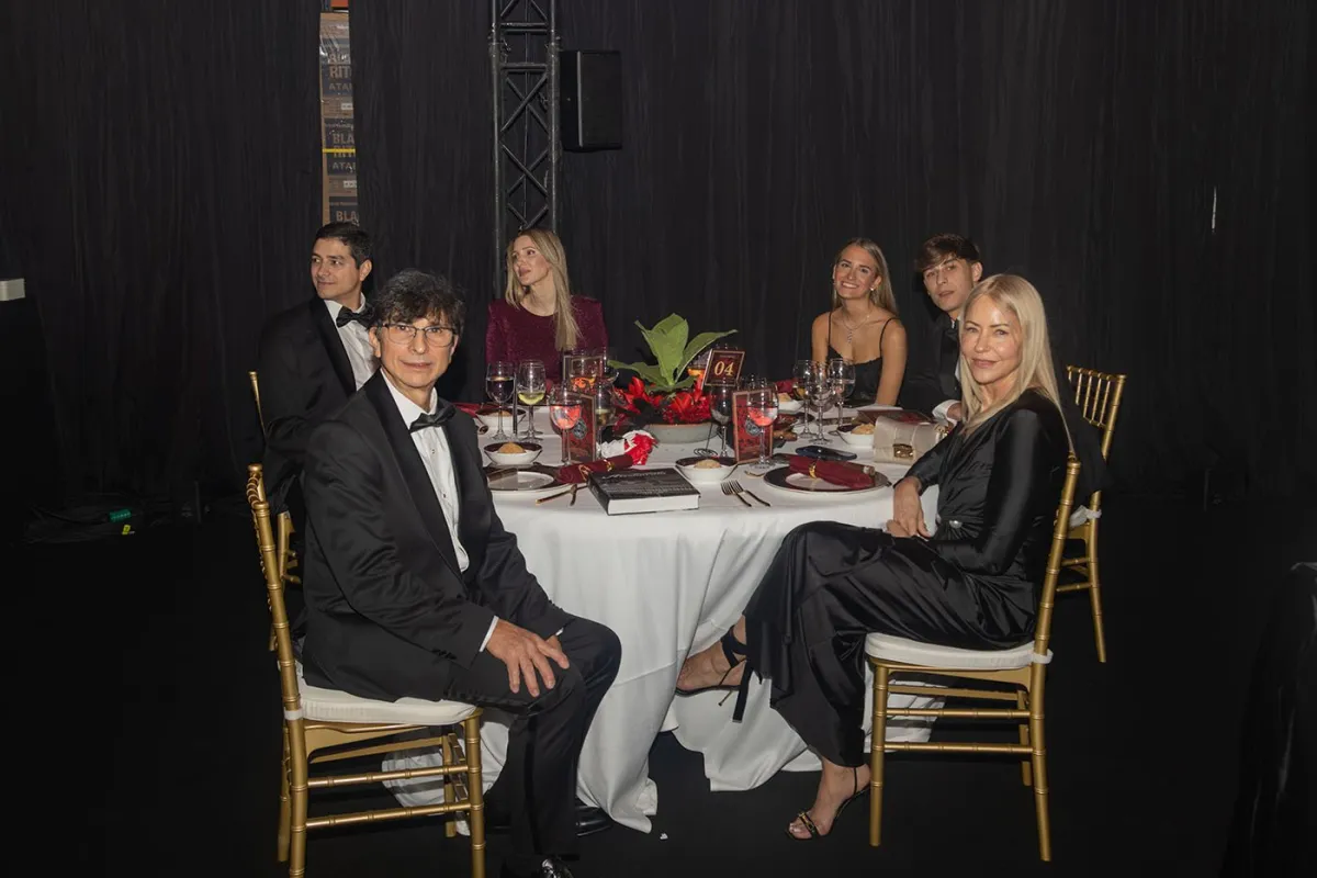 Guests in formal wear seated at a gala table at the Selected Tobacco grand opening in Madrid