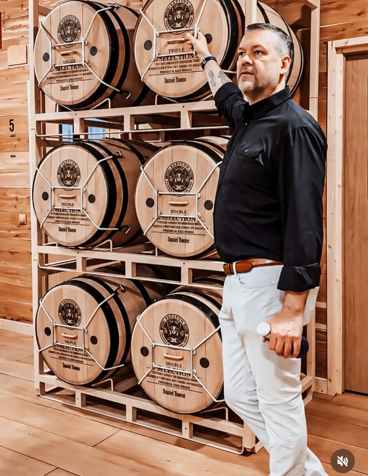 Racks of labeled oak barrels used for long-term aging at Selected Tobacco's Madrid facility