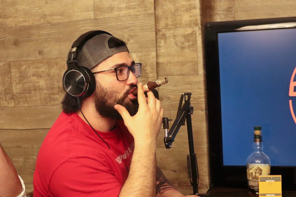 Mark smoking a cigar on the podcast
