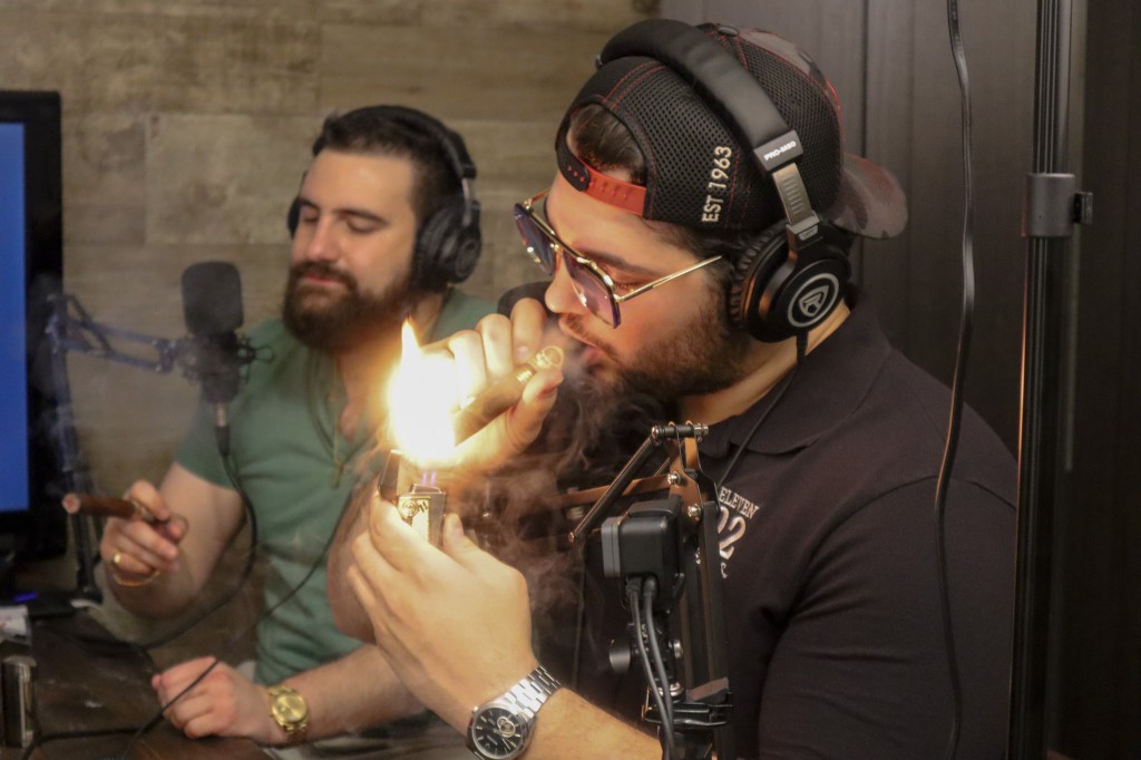 Zach lighting a Padron 1926 No. 90 cigar