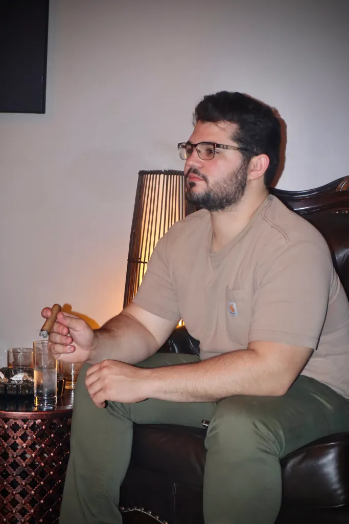 Zach smoking a cigar