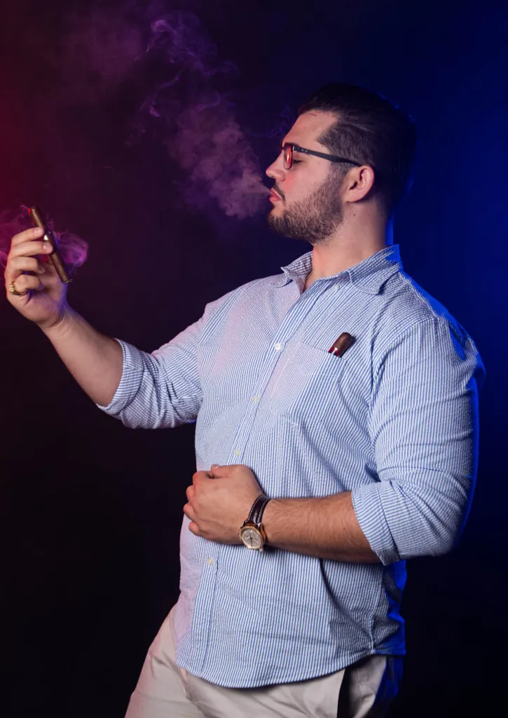 Zachary Nikollaj smoking a cigar
